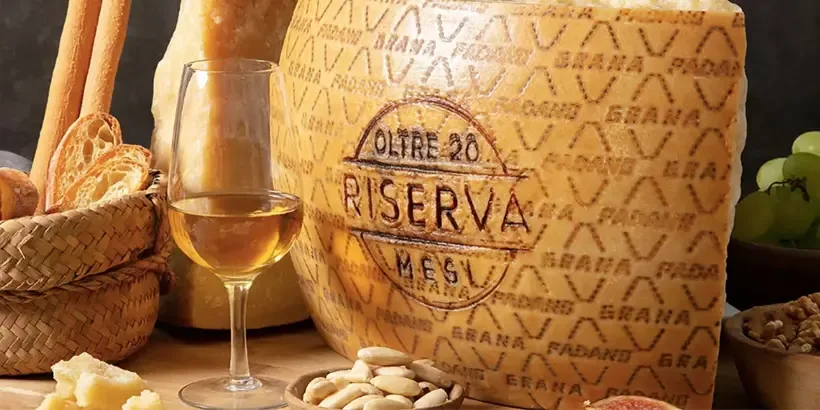 Grana Padano Riserva DOP s označením „Oltre 20 mesi“ servírovaný s vínem, ořechy a pečivem